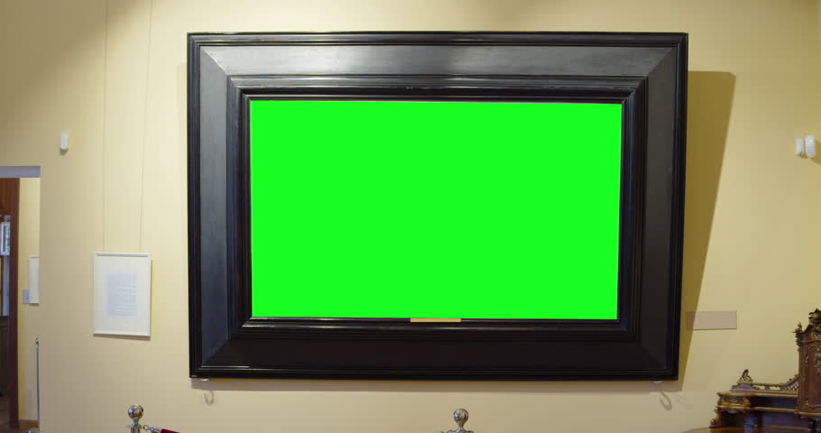 Woman in an art gallery near a painting with a green screen.