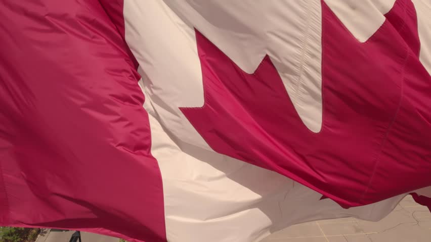 National Flag of Canada. Canadian flag slow motion at mast at Toronto city Ontario Canada in remembrance.