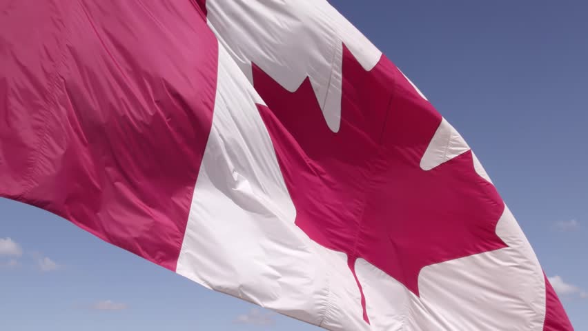 National Flag of Canada. Canadian flag slow motion at mast at Toronto city Ontario Canada in remembrance.