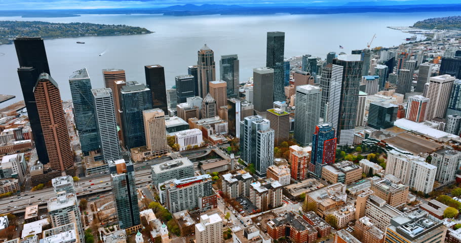 Distancing from the diverse modern downtown of Seattle, Washington, the USA. Revealing the beautiful city scenery at the backdrop of a lake. Top view.
