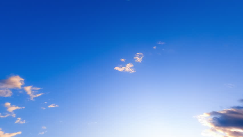 Wonderful blue sky with small clouds appearing and disappearing quickly. Low angle view on the horizon at day. Timelapse.