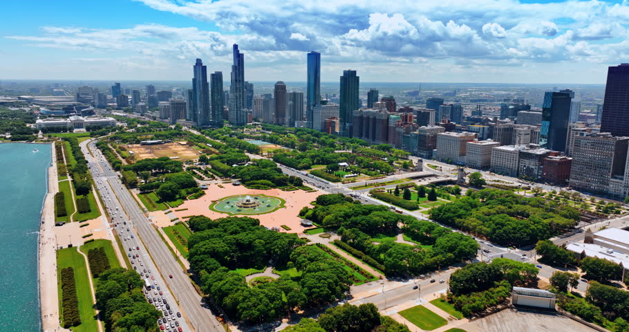 Huge city park Grant Park in Chicago Loop area, Chicago, Illinois, the USA. Beautiful green area neighboring with diverse buildings. Aerial view.