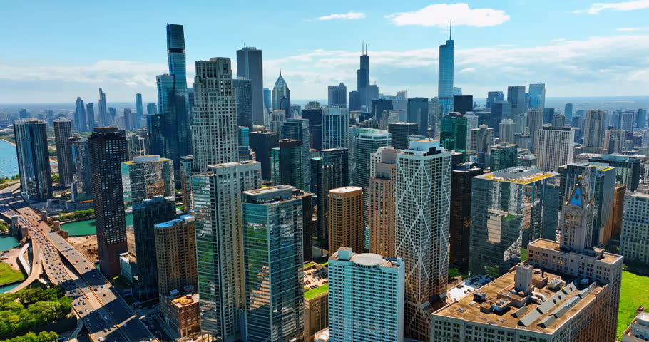 Rising over the stunning downtown of Chicago, Illinois, the USA. Modern skyscrapers are revealed to the sight on sunny day. Top view.