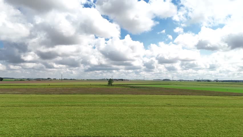 Aerial view of the green countryside north of Paris, showcasing vast fields and serene landscapes