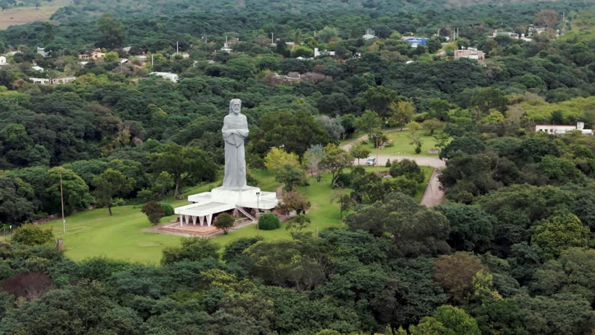 Aerial image approaching the "Cristo Penitente" (Penitent Christ) in the city of La Caldera, Salta, Argentina. Drone 4K.