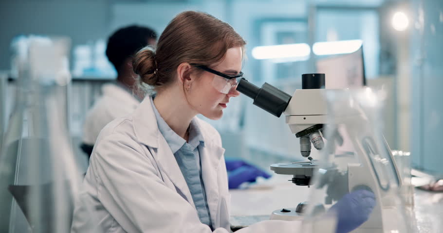 Science, laboratory and face of woman with microscope for research, analysis and vaccine development. Healthcare, med student and portrait of scientist with equipment for study, experiment and sample