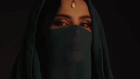 High-quality cinematic footage of a mysterious princess wearing a traditional veil and elegant jewelry, with an intense gaze. Perfect for cultural blogs, fashion promotions, and royal-themed content. - Powered by Shutterstock - Get 15% off with code: PIKWIZARD15