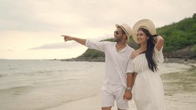 4K Happy Caucasian couple enjoy and fun outdoor lifestyle travel nature at the sea on summer beach holiday vacation. Man and woman walking and playing together at tropical island beach at sunset.  - Powered by Shutterstock - Get 15% off with code: PIKWIZARD15