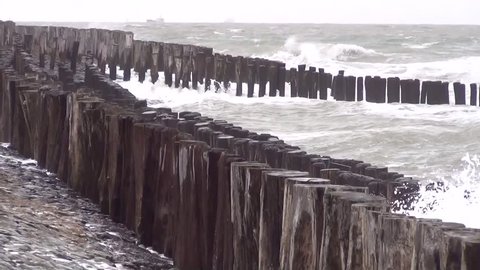 Wooden groynes and basalt on the North Sea
