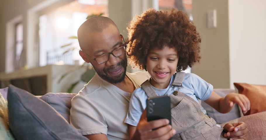 Father, son and play with phone, couch and happy in lounge, games and fun for bonding in house. Home, man and boy with mobile, gaming and child with smile, sofa and break in apartment and online