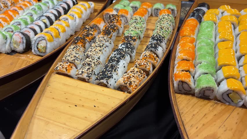 sushi buffet large selection of sushi on wooden boat-shaped plates restaurant buffet Asia Japanese food