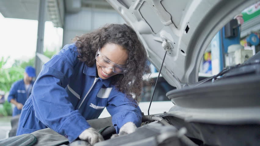 Automobile technician. Auto mechanics working on car. Manual workers repairing car in mechanic shop.