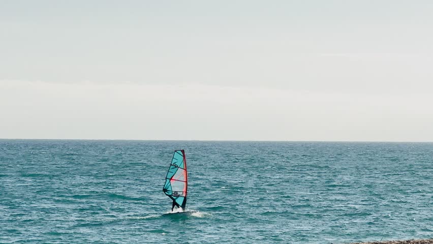 Man practicing the sport of windsurfing.