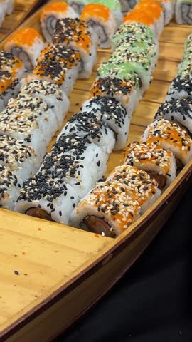 sushi buffet large selection of sushi on wooden boat-shaped plates restaurant buffet Asia Japanese food