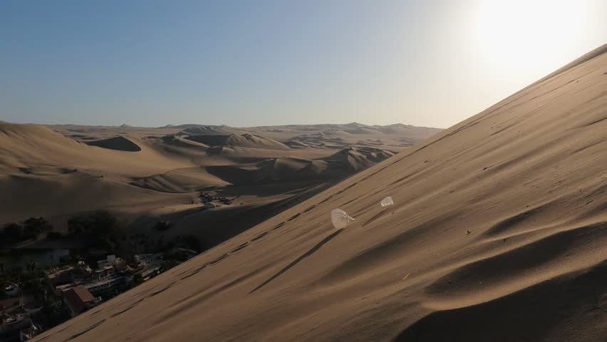 Beautiful sand dunes of Huacachina, Peru. Sunset. Slow motion steadicam footage.