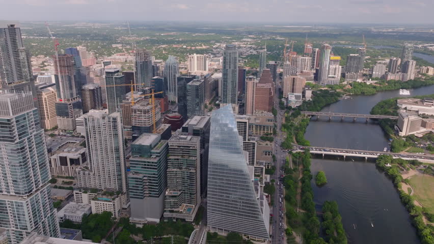 Dynamic cityscape of downtown Austin, Texas from above. Modern glass skyscrapers, parks, and busy streets create a vibrant metropolis scene