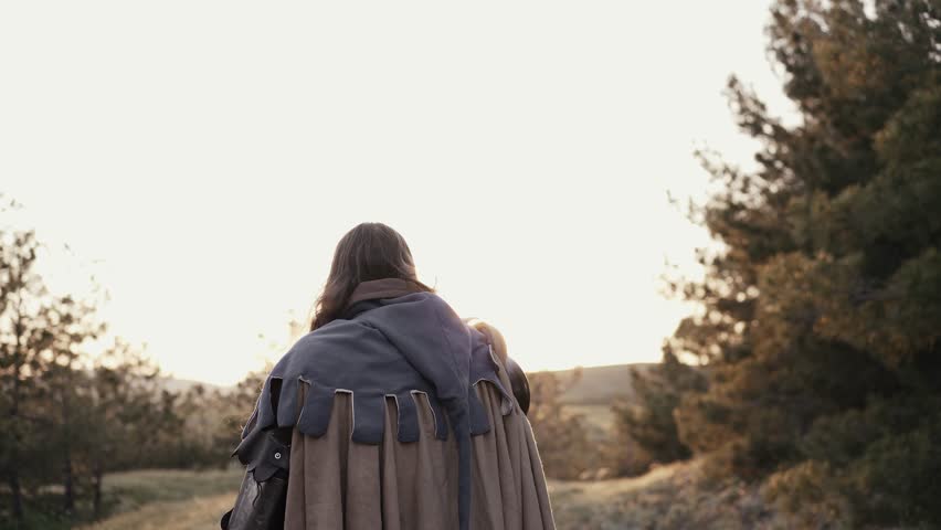 Warrior raises his sword up - celebrating victory