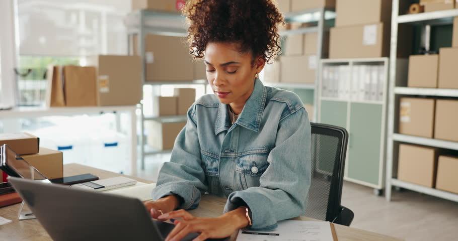 Delivery, typing and woman on laptop for shipping, distribution and courier service. Ecommerce, small business and person on computer for online shopping, logistics and email order with boxes