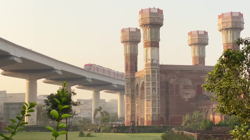  Lahore, Pakistan - 15th october, 2024: Chauburji - Mughal era monument in the city of Lahore, capital of the Pakistani province of Punjab. Public train pass in city center