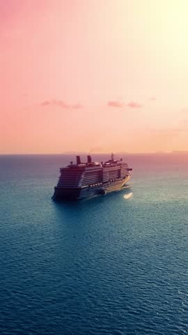 Cruise liner sailing the ocean or sea on a sunny summer day. Aerial top view of luxury large cruise ship. Aerial vertical, vertical video background.