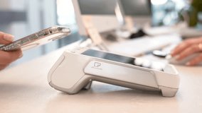 Pay by phone on electronic payment machine or card reader. E-money at cashless wallet. Female hand with pos-terminal and cellphone closeup. Client pays for the procedure in modern beauty clinic. - Powered by Shutterstock - Get 15% off with code: PIKWIZARD15