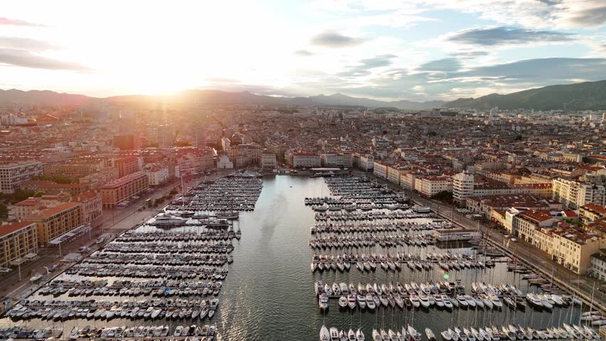 Aerial view of the city of Marseille, France in the morning sun The old port in Marseille. A large number of boats, sailboats, speedboats and yachts moored in the port, drone view