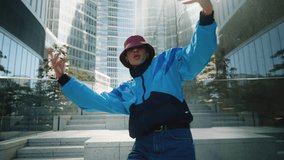Handsome female dancer performing modern street dance in downtown. Creative young woman dancing near high-rise skyscrapers in city. Contemporary choreography, retro 80s urban style brunette girl - Powered by Shutterstock - Get 15% off with code: PIKWIZARD15