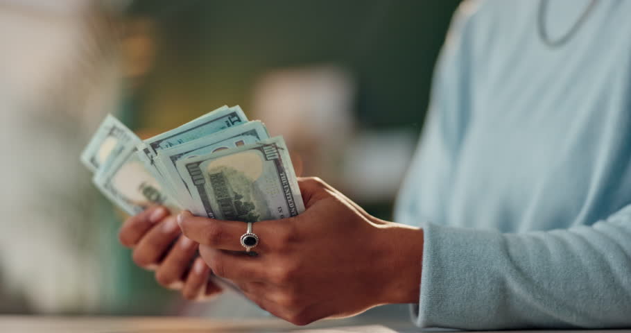 Hands, bank notes and counting at table for profit, dollars and investment in living room. Money laundering, cash and female person with wealth from crime, trading and illegal business from home
