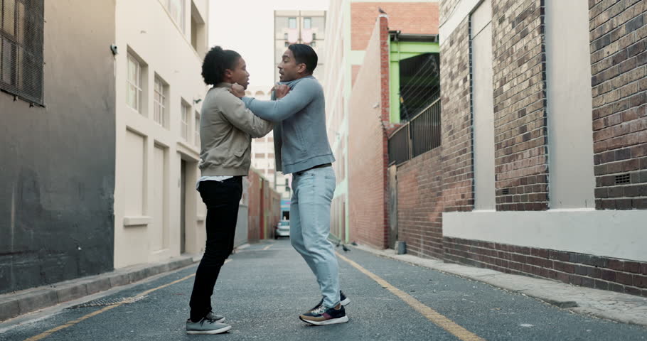 City, conflict and men fight with violence, battle and disagreement with problem, aggression and pushing. Argument, bullying and angry friends in street brawl in urban alley with frustrated danger