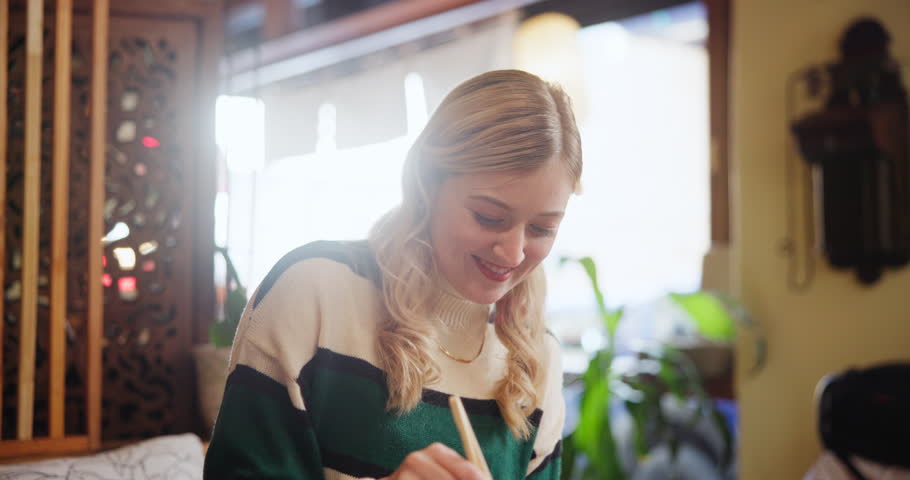 Happy, couple and laughing from feeding food with love, bonding and care of date romance at restaurant. Smile, woman and man together for fine dining lunch, taste test or eating sushi with nutrition
