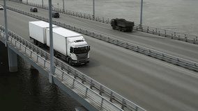 Long distance truck freight. Big lorry cargo transportation drone view from above. Large van drive city street highway. Road way logistic. Fast heavy semi trucks goods delivery. Trucker driver move. - Powered by Shutterstock - Get 15% off with code: PIKWIZARD15