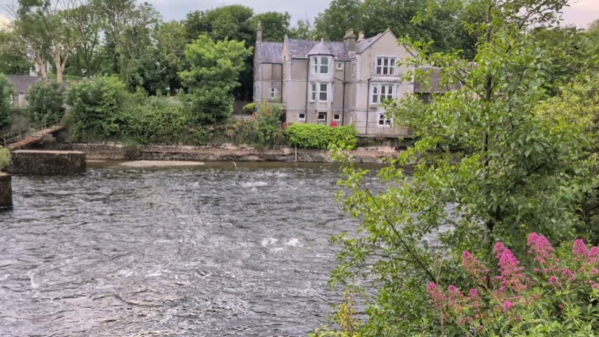 Old buildings and architecture by the Corrib river at Galway city, Ireland, Irish landmarks, 4k revealing  shot