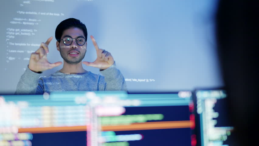 An Asian male tech specialist passionately explains coding concepts during a nighttime team meeting. - Powered by Shutterstock - Get 15% off with code: PIKWIZARD15