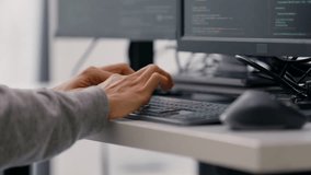 A close-up shot of a professional programmer’s hands typing code on a keyboard, with multiple monitors displaying lines of code in the background. - Powered by Shutterstock - Get 15% off with code: PIKWIZARD15
