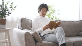 man sitting on sofa and reading - Powered by Shutterstock - Get 15% off with code: PIKWIZARD15