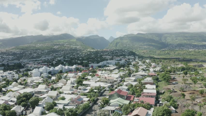 Pan shot of Reunion Island, France with Saint-Denis City. Aerial view.