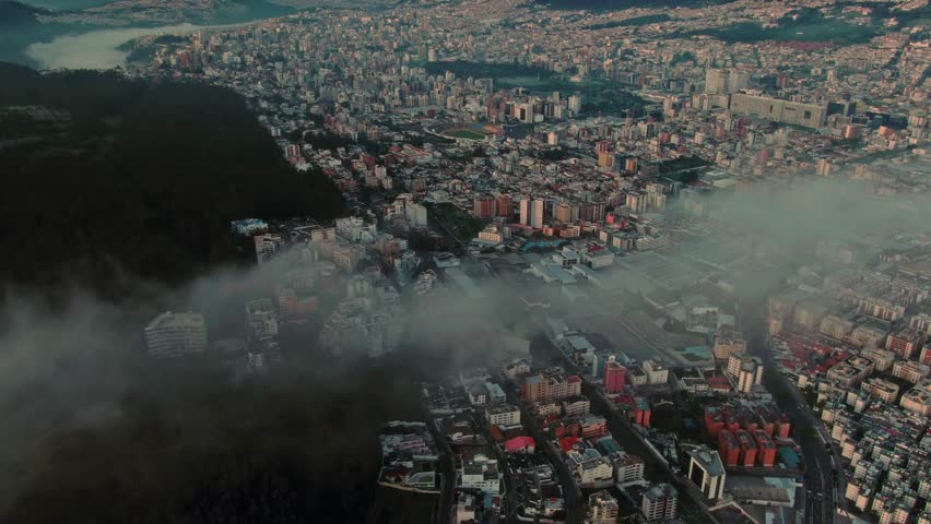 An aerial view of a city in the hills at dusk