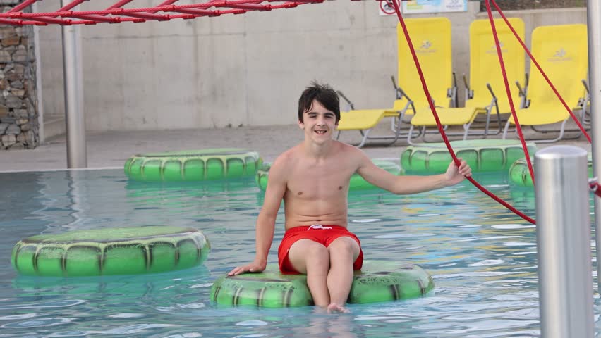 Cute child, boy in water park, having fun summertime
