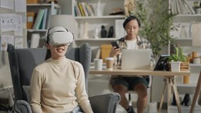 Young asian man use laptop at home and asian woman using virtual reality(VR) for watch concert streaming in living room at home.relax and work at home concept. - Powered by Shutterstock - Get 15% off with code: PIKWIZARD15