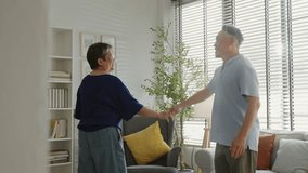 Happy senior asian husband and wife have fun sing and dancing in living room together at home.Overjoyed happiness Elderly asian couple retirement feel energetic active enjoy family retirement weekend. - Powered by Shutterstock - Get 15% off with code: PIKWIZARD15