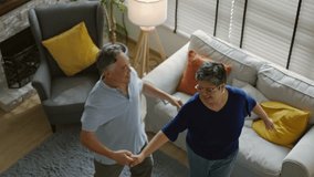 Happy senior asian husband and wife have fun sing and dancing in living room together at home.Overjoyed happiness Elderly asian couple retirement feel energetic active enjoy family retirement weekend. - Powered by Shutterstock - Get 15% off with code: PIKWIZARD15