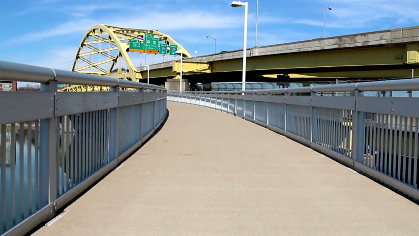 Walking on the pedestrian walkway on the Fort Duquesne Bridge in Pittsburgh,