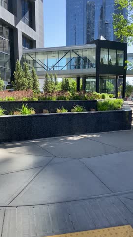The city skyline of Downtown Calgary in Alberta, Canada is beautiful with modern tall buildings representing the financial and government district, clean lamdscape with green grass and Treeline 