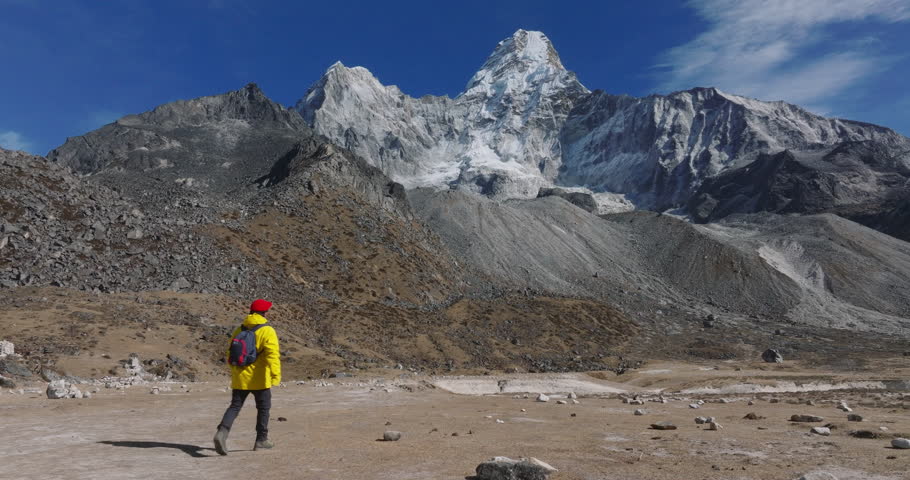 Aerial drone footage of Ama Dablam base camp, Nepal. Male trekker en route to Everest Base Camp, surrounded by stunning mountainous landscape. High-resolution, breathtaking view.