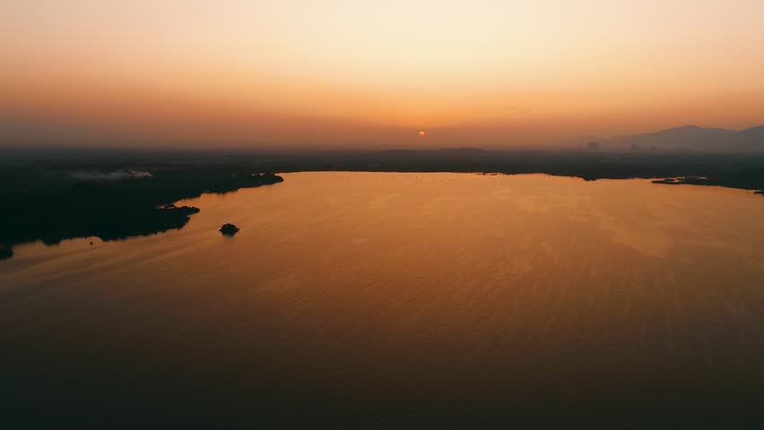 Aerial view over the water of the lake view with sunset views and sun reflections. Lake View 