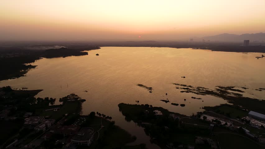 Aerial view over the water of the lake view with sunset views and sun reflections. Lake View 