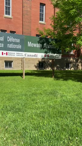 A red brick building, of ancient English architecture, located in Calgary downtown is home to Canada’s national defence department, featuring armoury war tanks placed on the green lawn for display