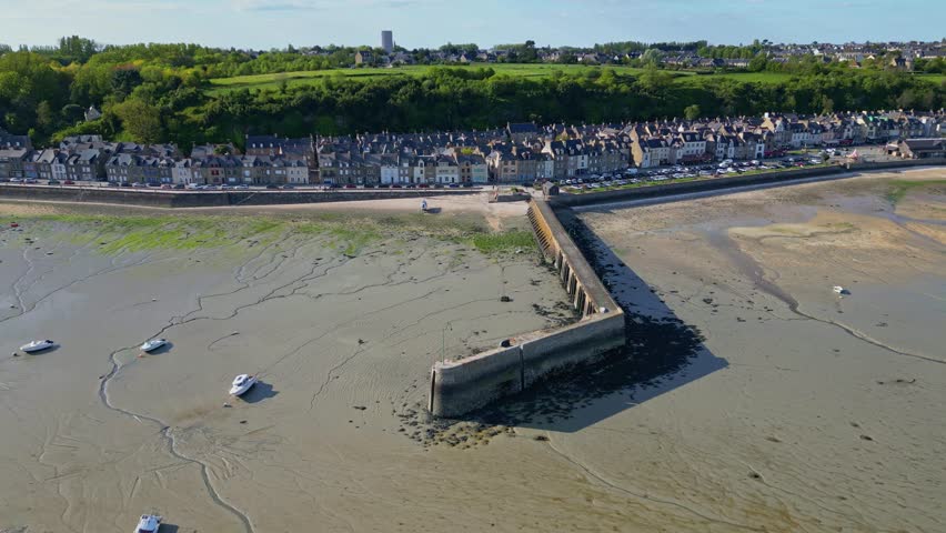 Cale de l'Épi pier and beach during low tide, Cancale in Brittany, France. Aerial drone sideways