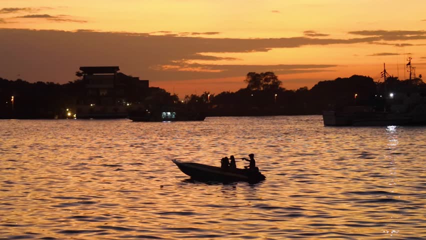 Boat on the water at orange sunset Malaysia