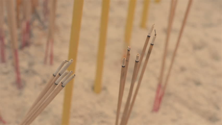 Burning incense sticks planted in sand, at a temple in Chinatown, Bangkok,